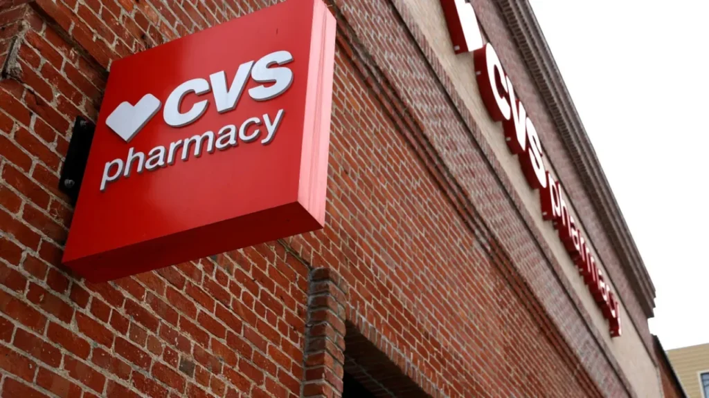 Red CVS Pharmacy sign on a brick building: Is CVS Open on the 4th of July