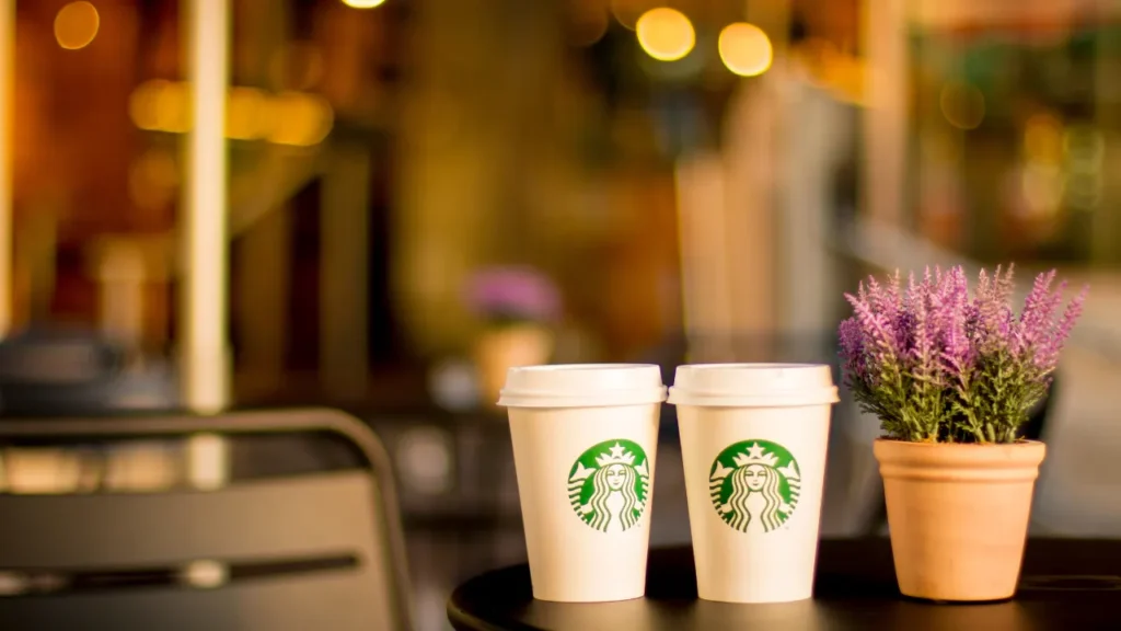 Starbucks Cups Resting on A Table Next To A Lavender Pot - Is Starbucks Open on Labor Day?