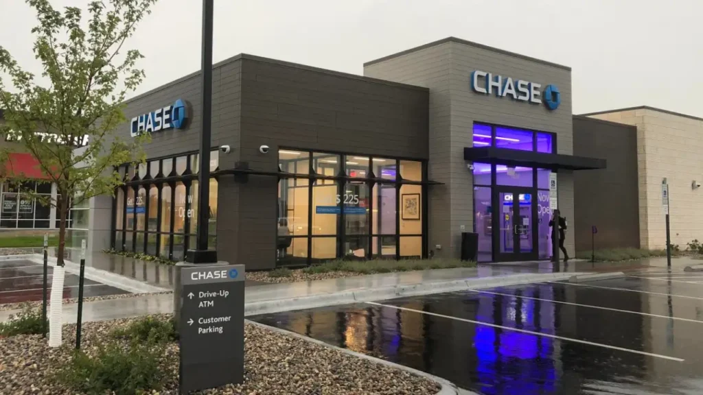 A Modern Chase Bank Branch Building Exterior on A Rainy Day with Directional Signs for The Drive-Up ATM and Customer Parking - Chase Bank Hours